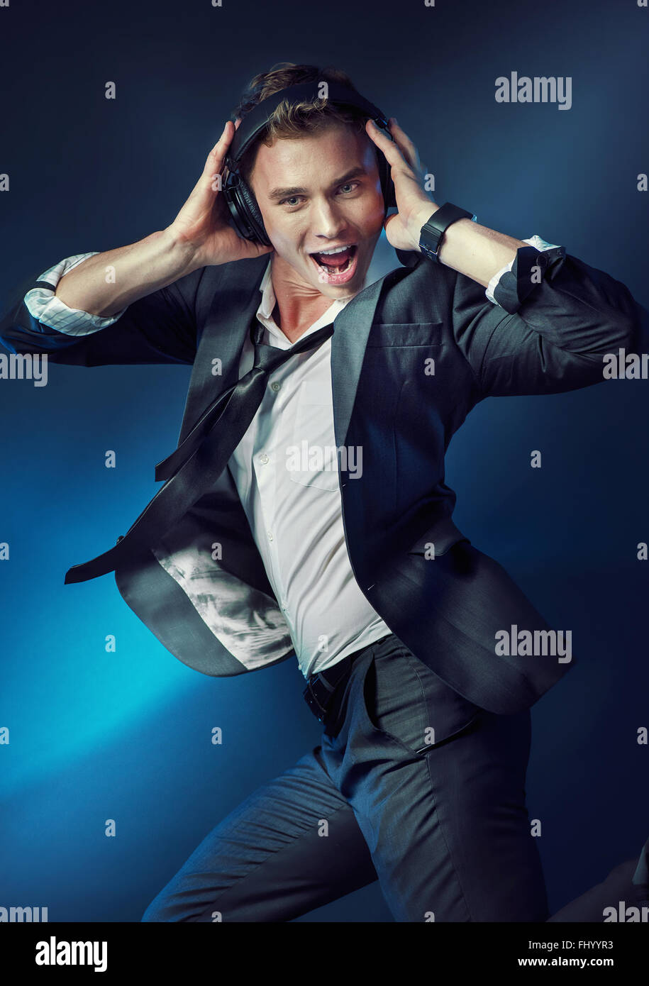 Surprised young guy listening to loud note Stock Photo - Alamy