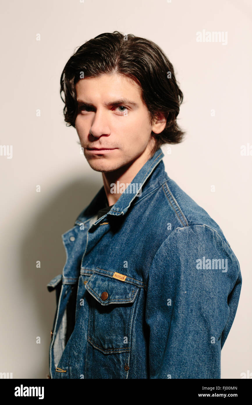 Attractive young man in a jeans jacket. Stock Photo