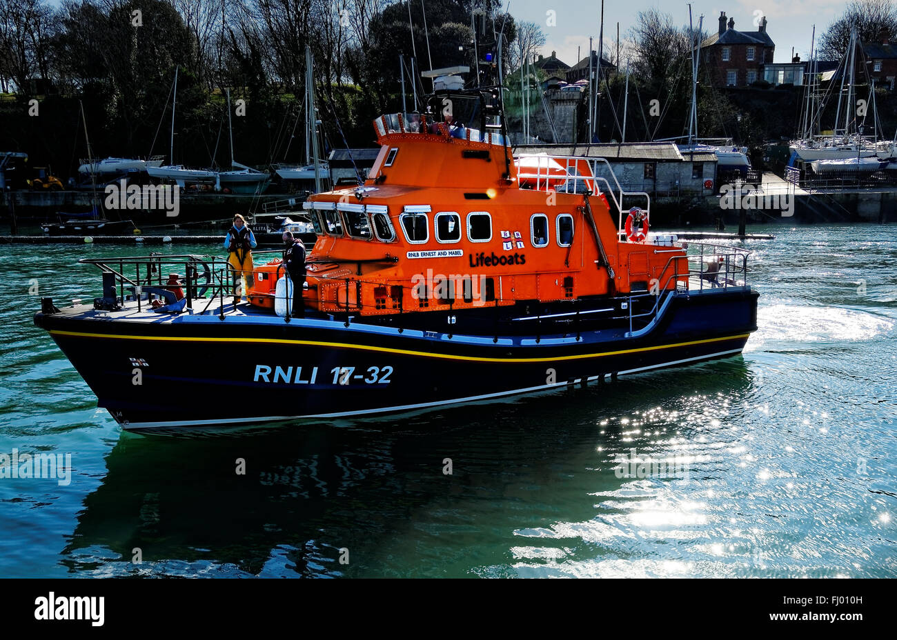 The RNLI lifeboat 'Ernest and Mabel' comes palcidly in to dock in the harbour at Weymouth, UK Stock Photo