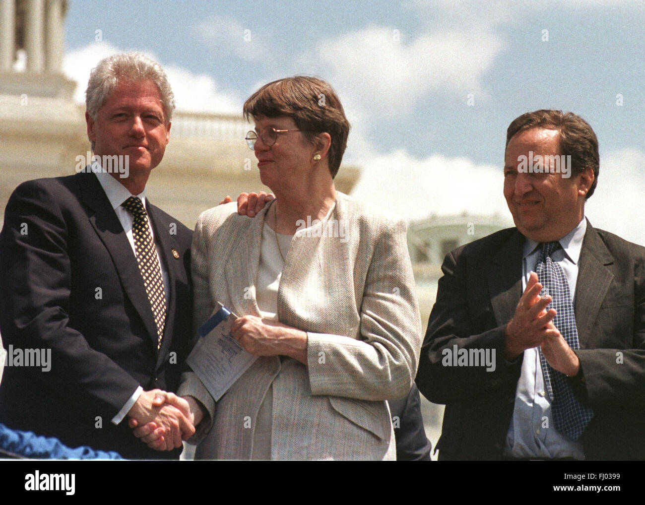 United States President Bill Clinton, left, shakes hands with US Attorney General Janet Reno, center, as US Secretary of the Treasury Lawrence Summers, right, looks on at the 19th annual Fraternal Order of Police Peace Officers Memorial in front of the US Capitol in Washington on May 15, 2000. Credit: Ron Sachs/CNP - NO WIRE SERVICE - Stock Photo