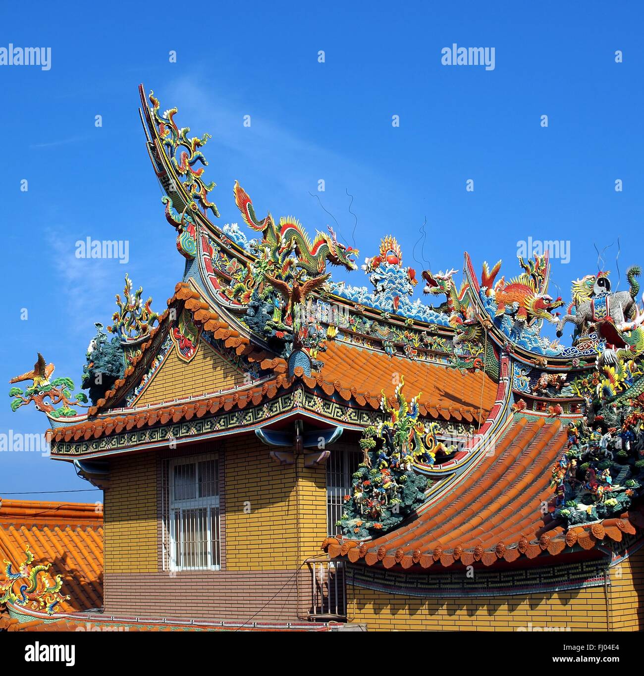 A Chinese temple with colorful decorations of mythological beasts Stock