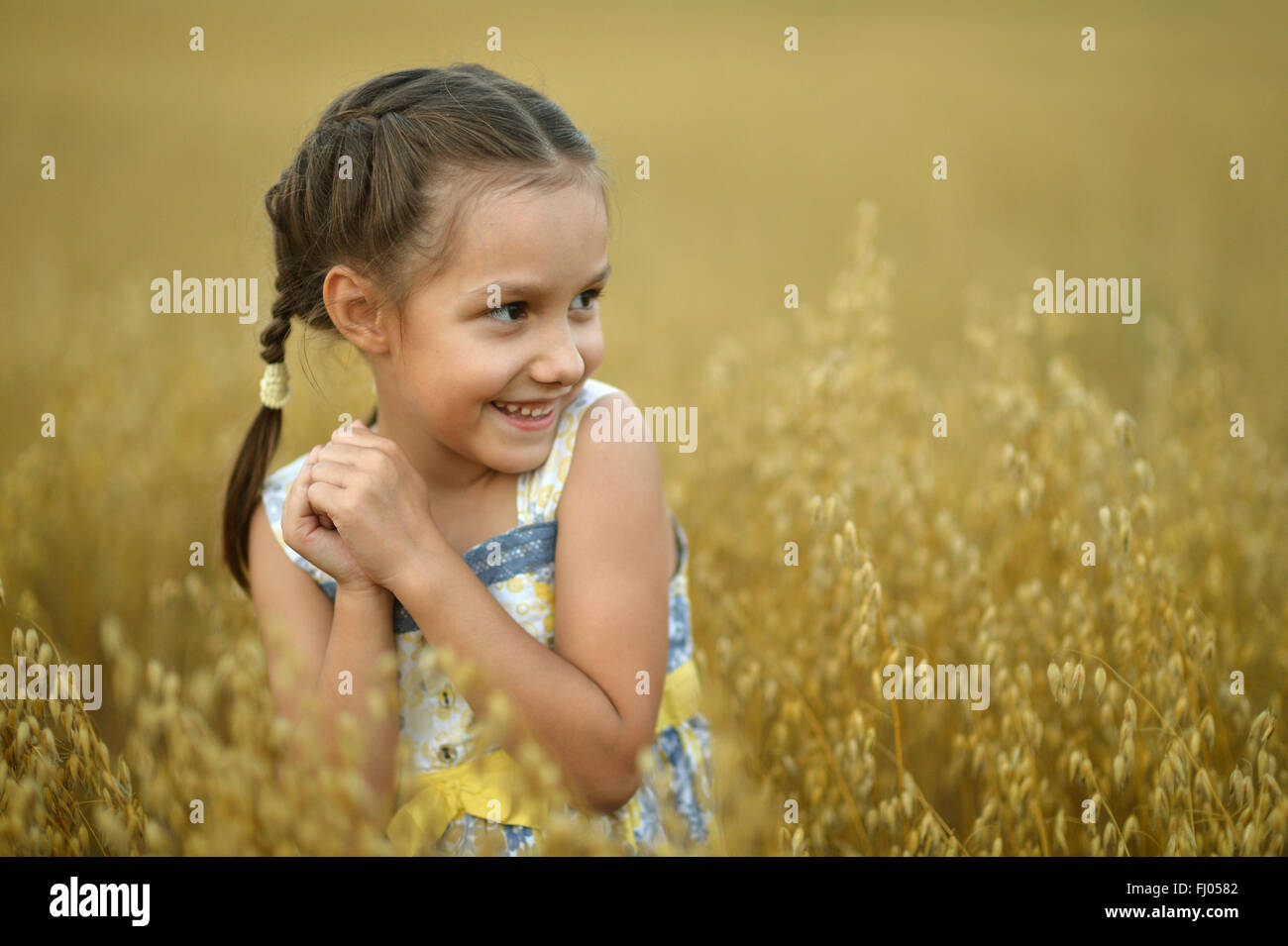 Little girl in wheat field Stock Photo - Alamy
