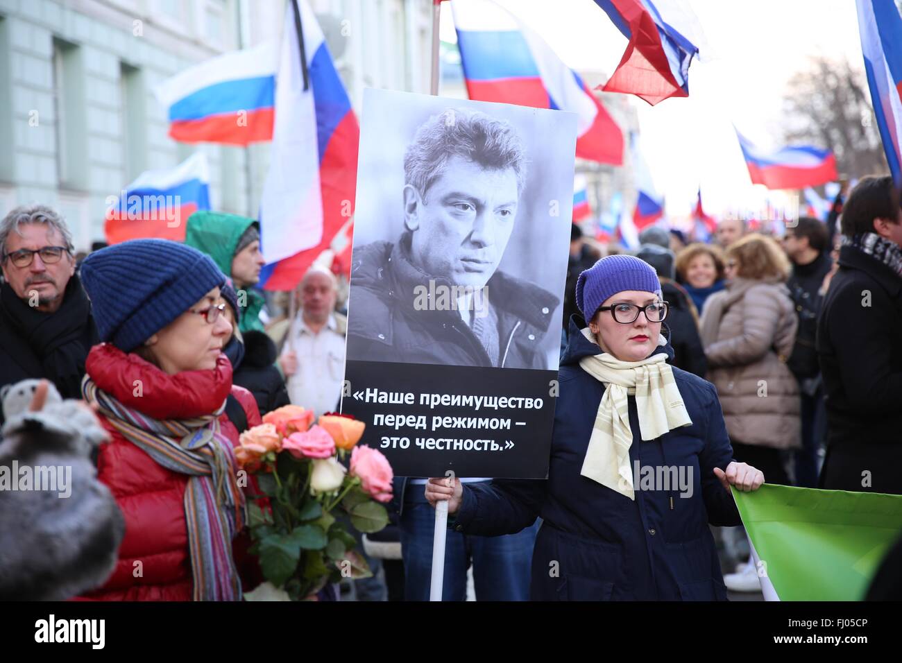 Moscow, Russia. 27th Feb, 2016. A woman holds a banner reading 'Honest is our superiority before system' during a march in memory of Russian opposition politician Boris Nemtsov on the first anniversary of his murder in Moscow, Russia, on Feb. 27, 2016. About 50,000 mourners of Nemtsov gathered here on Saturday for a mass march. Nemtsov, former Russian deputy prime minister and an outspoken critic of President Vladimir Putin, was shot dead at about midnight on Feb. 27, 2015 near the Kremlin. Credit:  Bai Xueqi/Xinhua/Alamy Live News Stock Photo