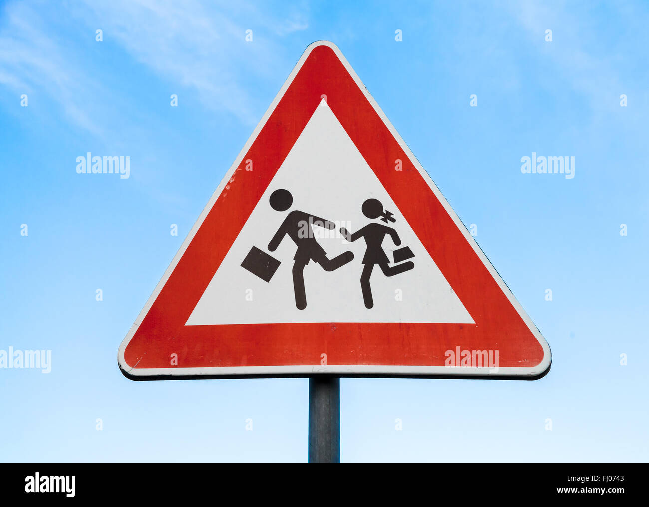 Road sign caution children over blue sky background Stock Photo