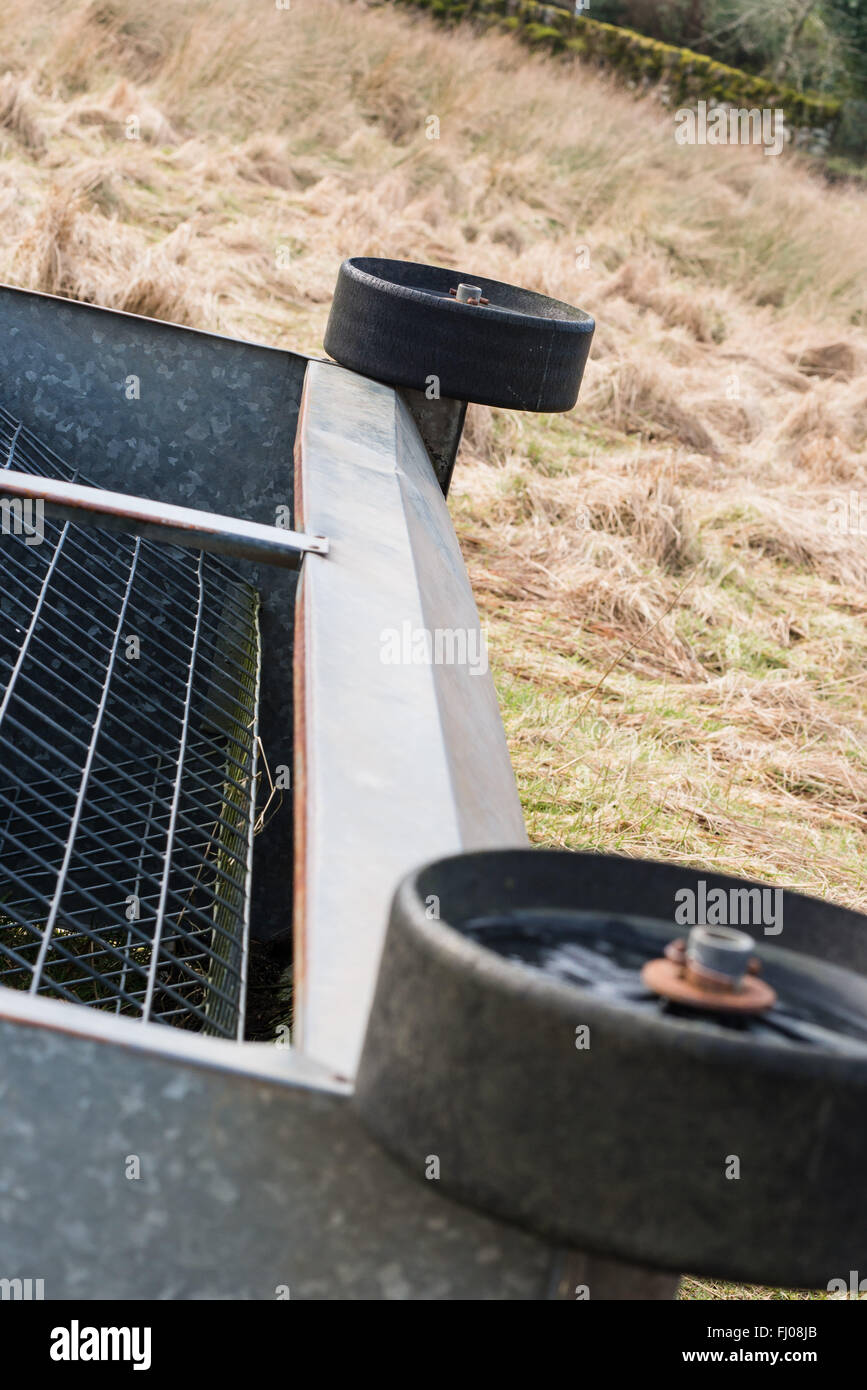 metal cattle feeder lying on side in rural location Stock Photo Alamy