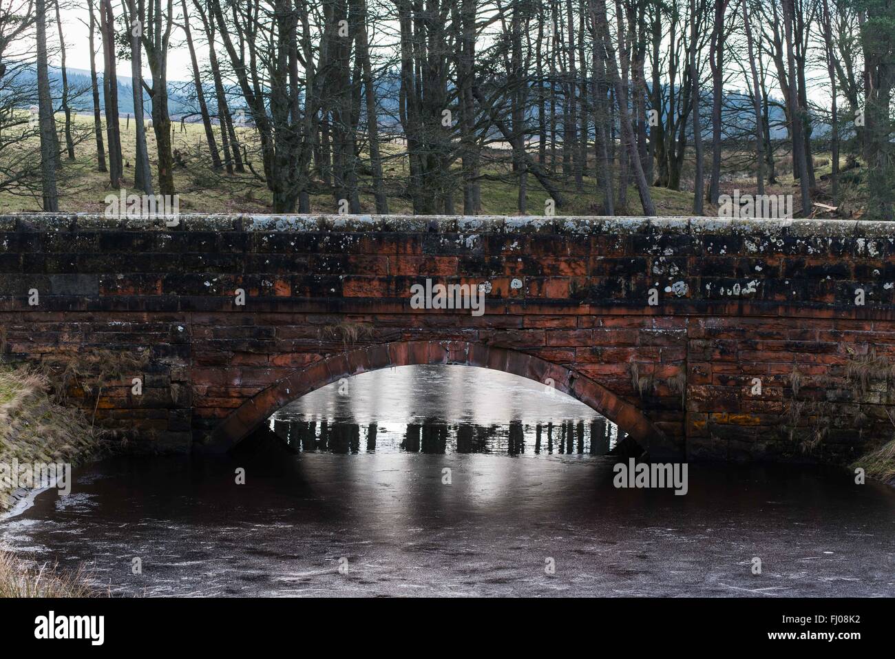 Old stone bridge at harperrig reservoir, the start of the water of leith Stock Photo