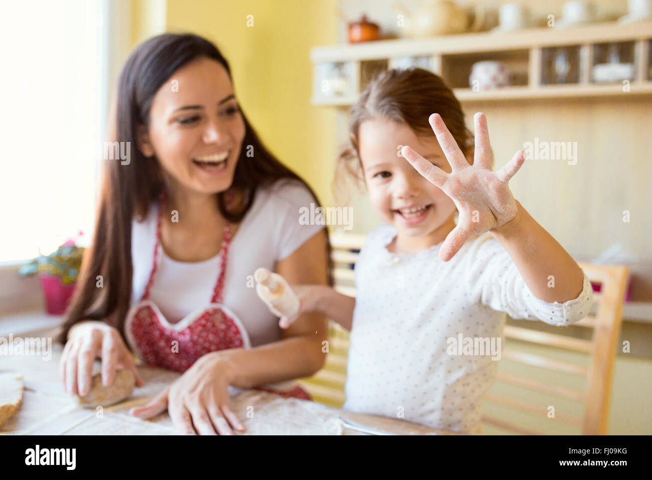 Little girl showing her hand covered with flour Stock Photo Alamy