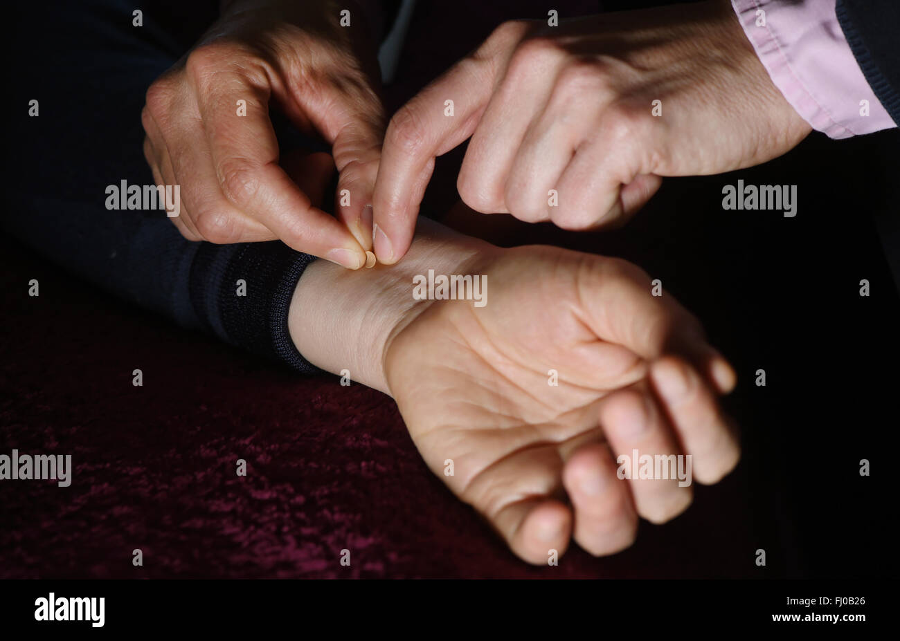 Berlin, Germany. 25th Feb, 2016. A small gold sphere is glued to a