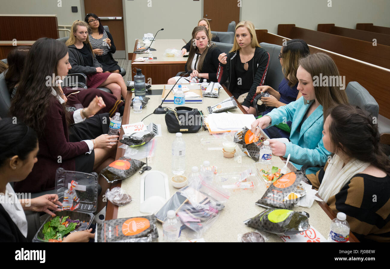 Teen girls serving on defense team during mock trial eat lunch during deliberations in court room in San Marcos Texas Stock Photo