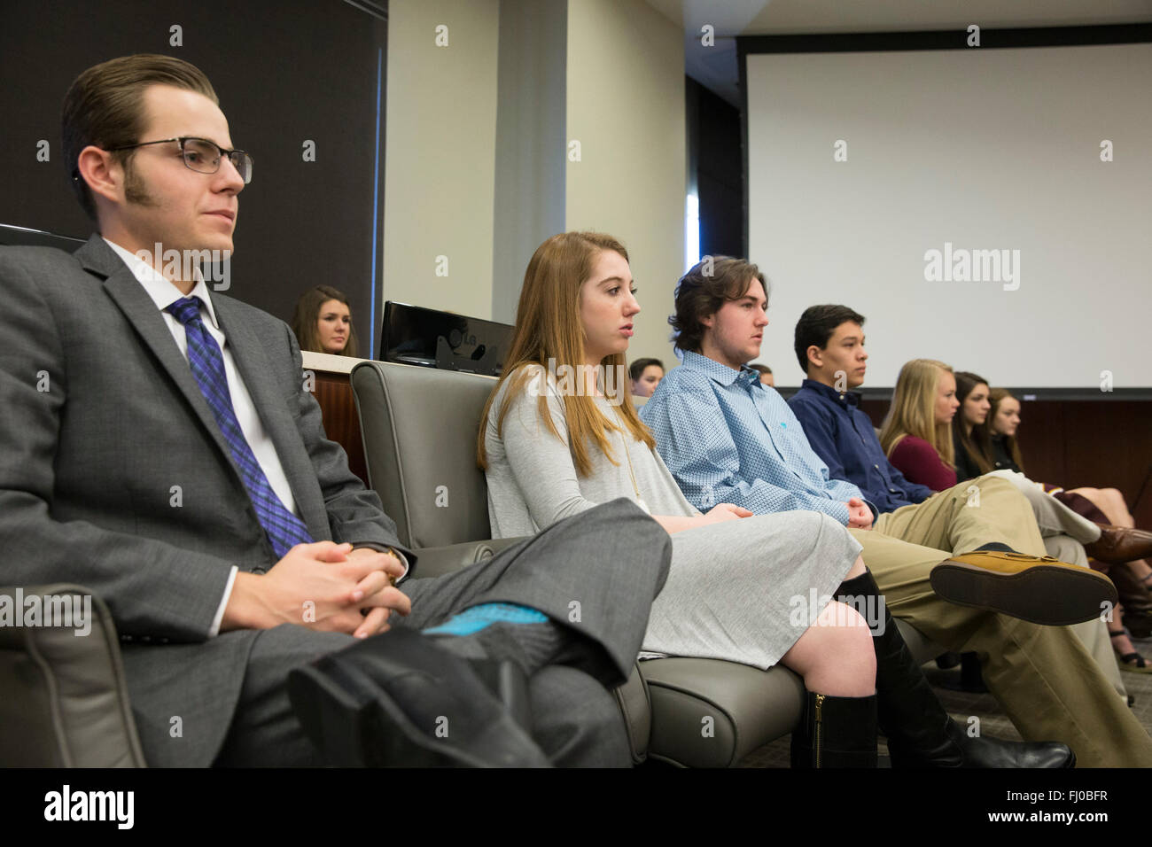 Teens posing as jurors listen to proceedings in county courtroom during mock trial for high school students in Texas Stock Photo