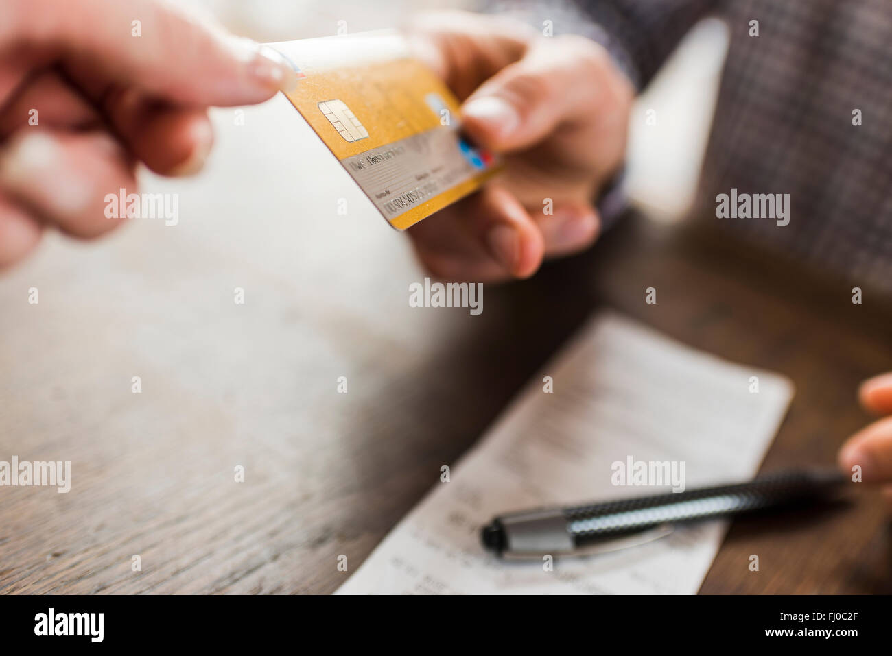 Close-up of tow hands with credit card Stock Photo