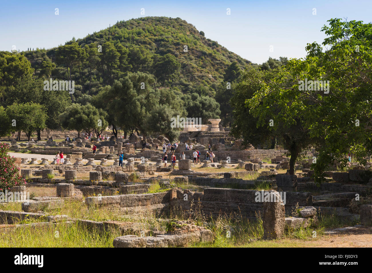 Olympia, Peloponnese, Greece.  Ancient Olympia.  Groups of visitors strolling through the ruins. Stock Photo