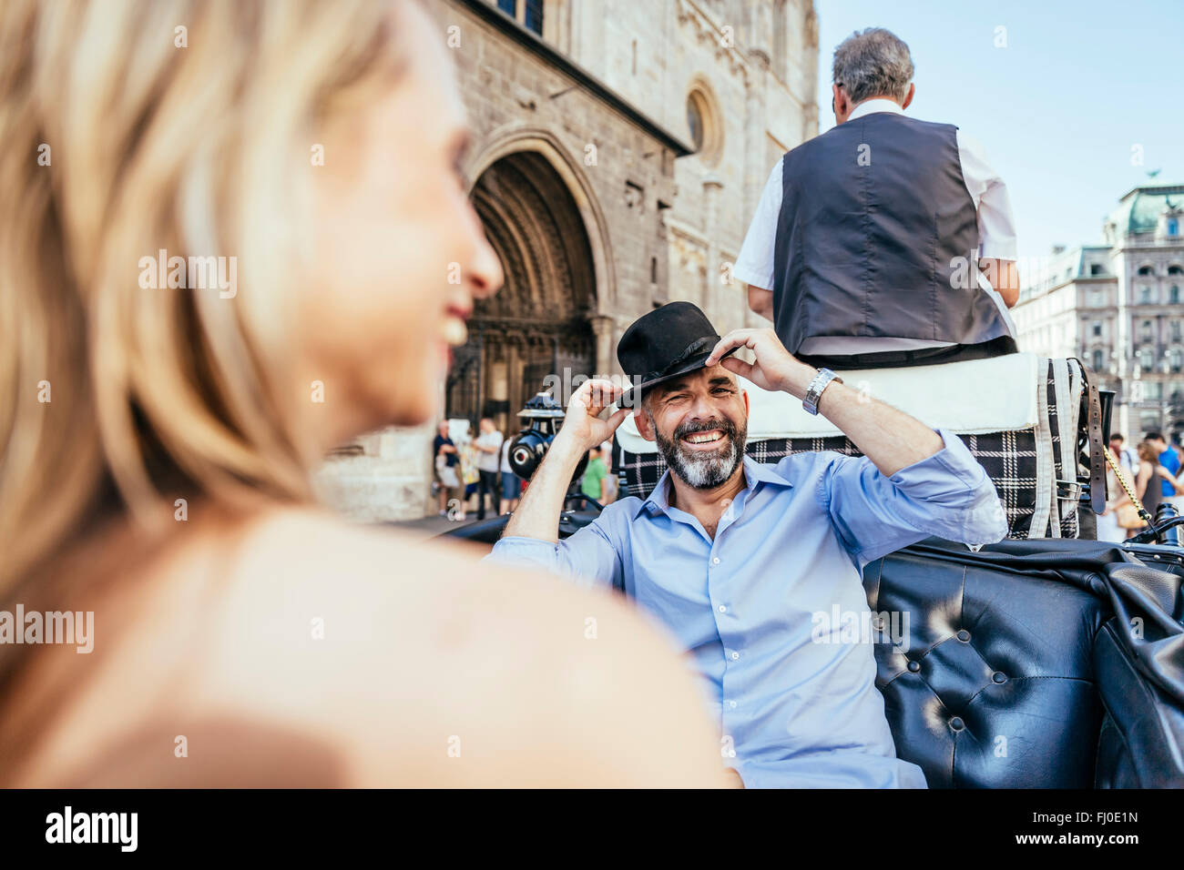 Austria, Vienna, couple having fun on sightseeing tour in a fiaker Stock Photo