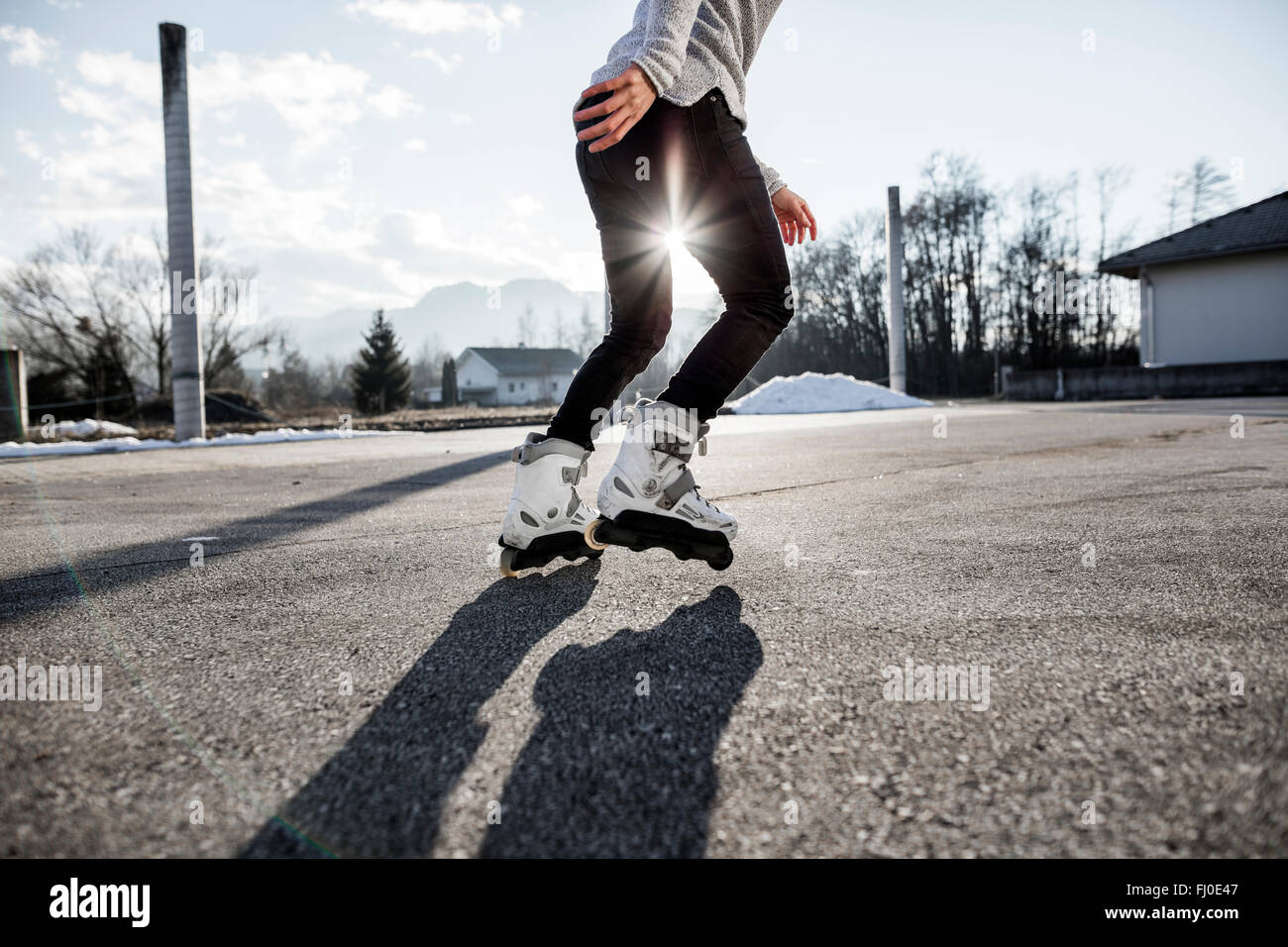 Low section of young man inline skating Stock Photo