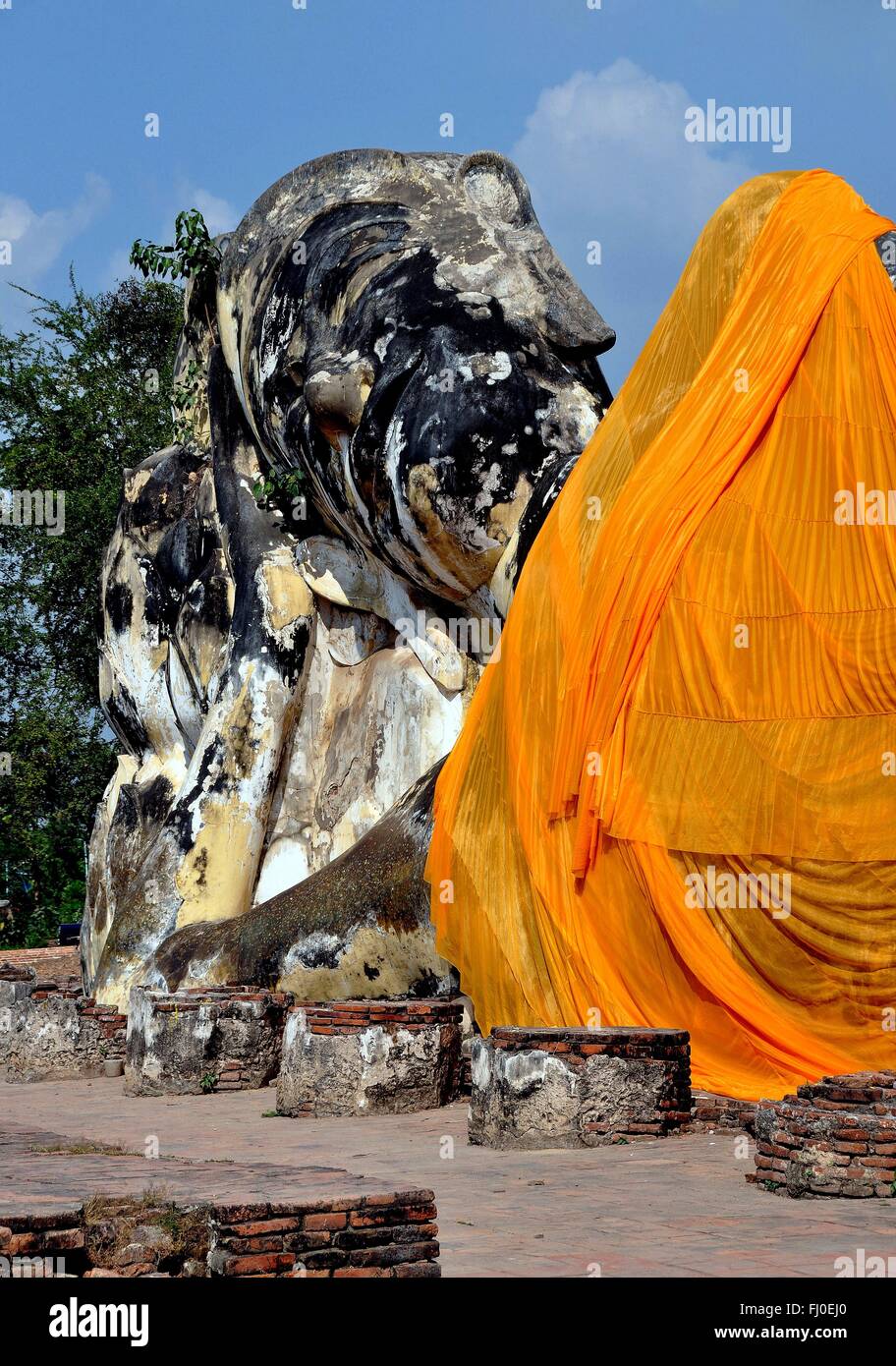 Ayutthaya, Thailand:  The great reclining Buddha with a bright orange sash is all that remains of Wat Lokaya Sutha Stock Photo