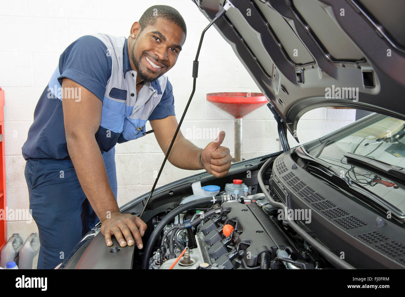 African-American Auto Tech Give Thumbs Up Stock Photo
