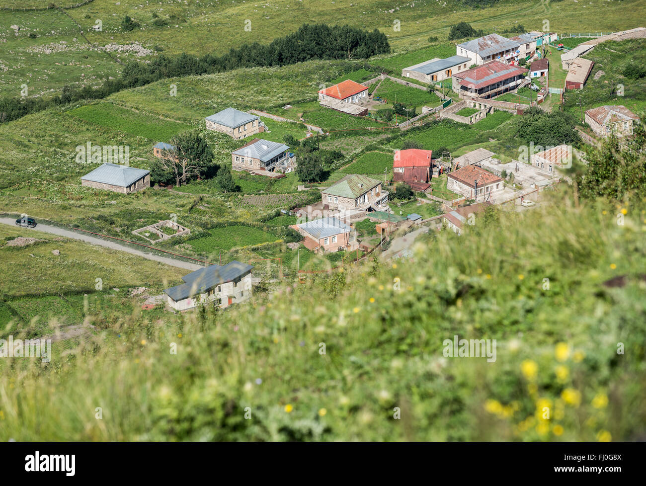 Houses in Gergeti village in Mtskheta-Mtianeti region, Caucasus Mountains, Georgia Stock Photo