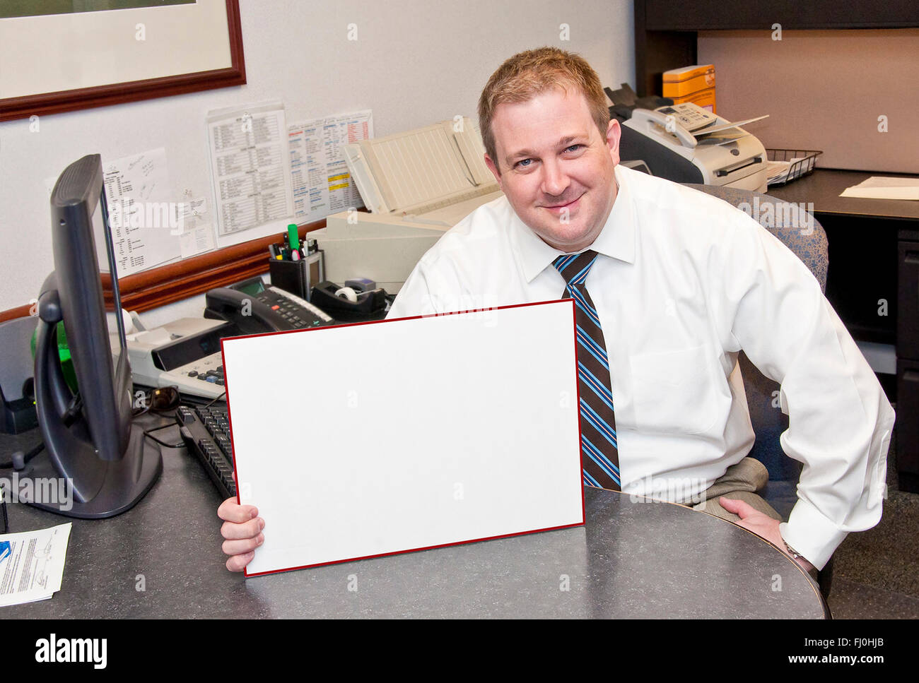 Amused Businessman With Blank Sign Stock Photo