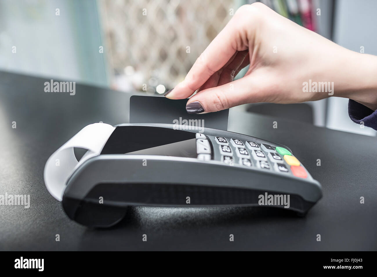 Debit card swiping on pos terminal Stock Photo Alamy