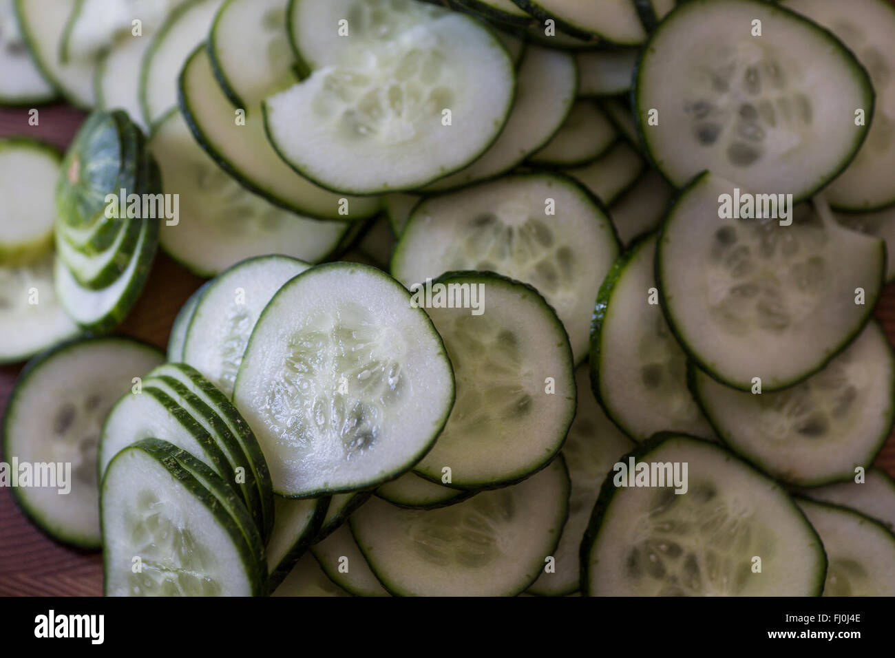 Picture shot from above down in bowl of sliced cucumbers. Stock Photo