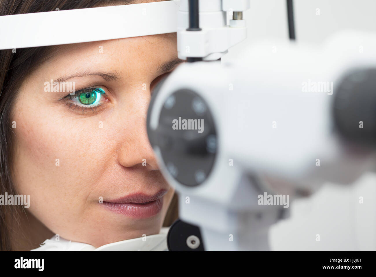 Woman at the optometrist making an eye test Stock Photo Alamy