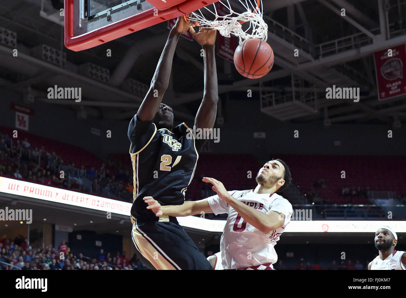 Philadelphia, Pennsylvania, USA. 27th Feb, 2016. UCF Knights center TACKO FALL (24) finishes a slam dunk in front of Temple Owls forward OBI ENECHIONYIA (0) during the NCAA basketball game played at the Liacouras Center in Philadelphia. Temple beat UCF 63-61. Credit:  Ken Inness/ZUMA Wire/Alamy Live News Stock Photo
