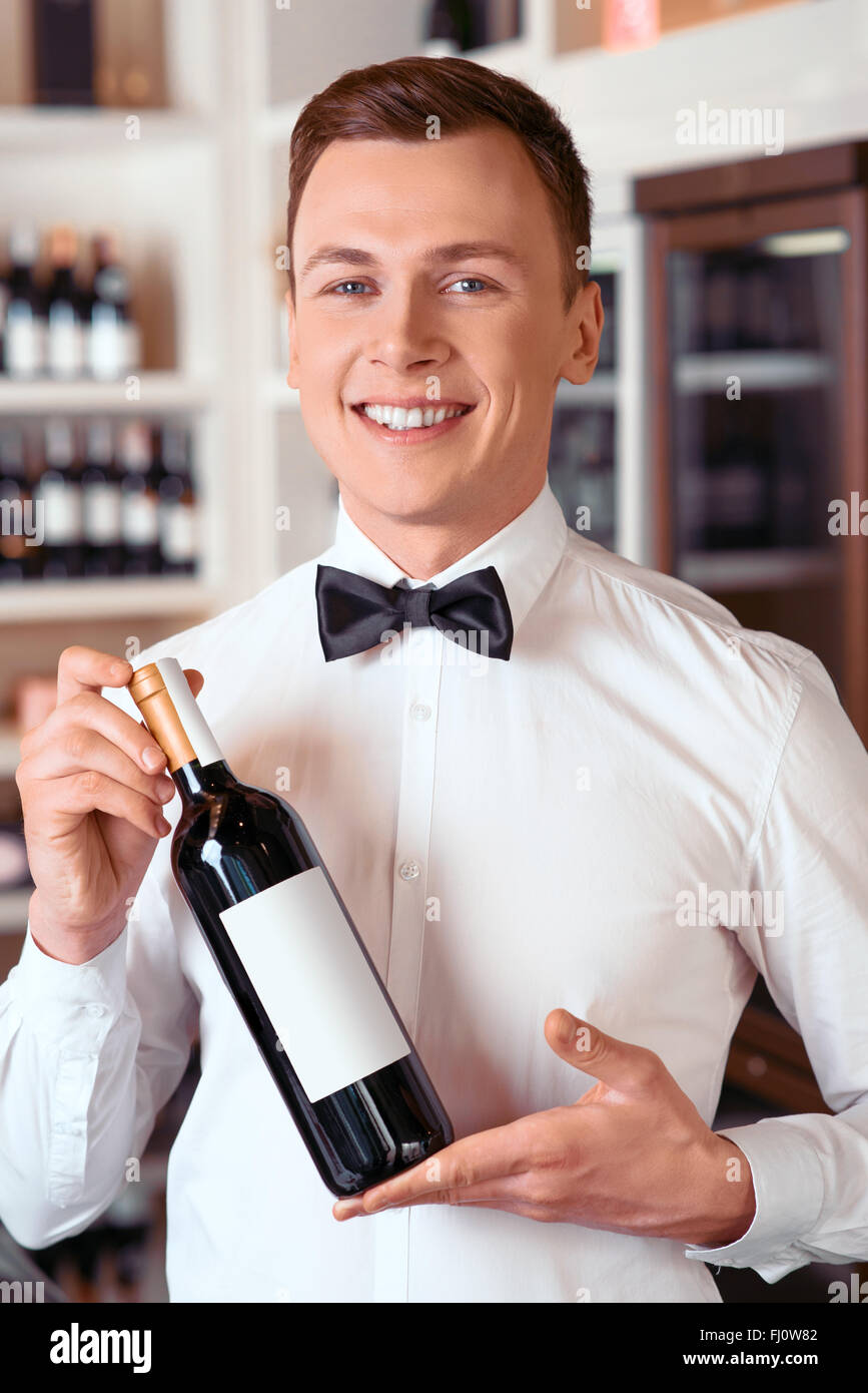 Professional sommelier holding wine bottle Stock Photo
