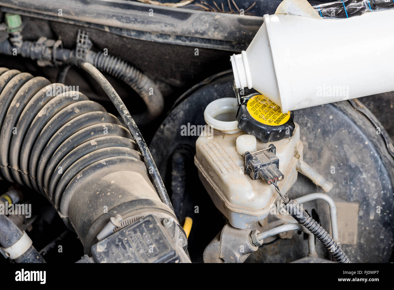 Pouring brake fluid into master cylinder Stock Photo Alamy