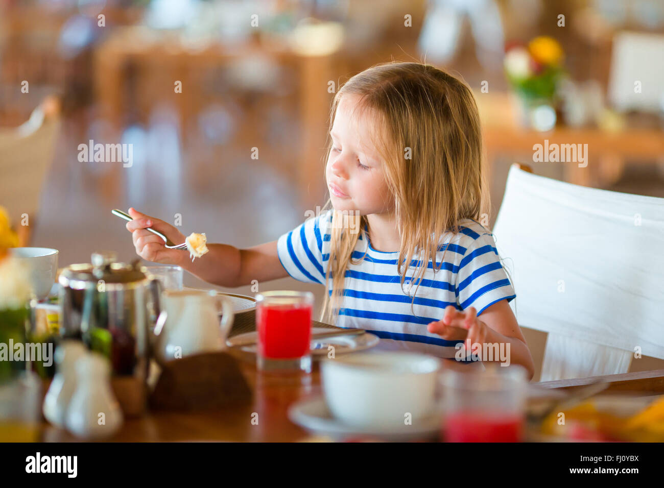 Breakfast Little Adorable little girl having breakfast at outdoor cafe Stock Photo - Alamy