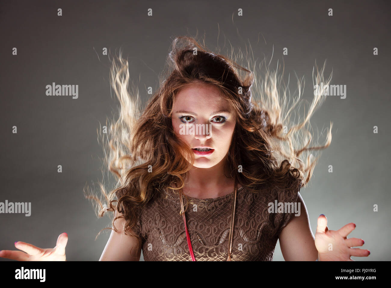 Portrait of mysterious enigmatic woman in studio on grey. Young ...