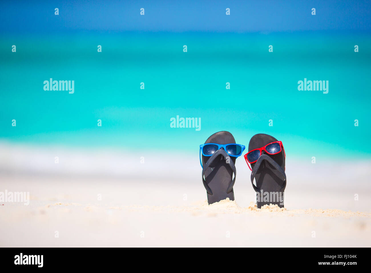 Summer flip flops with sunglasses on white beach Stock Photo - Alamy