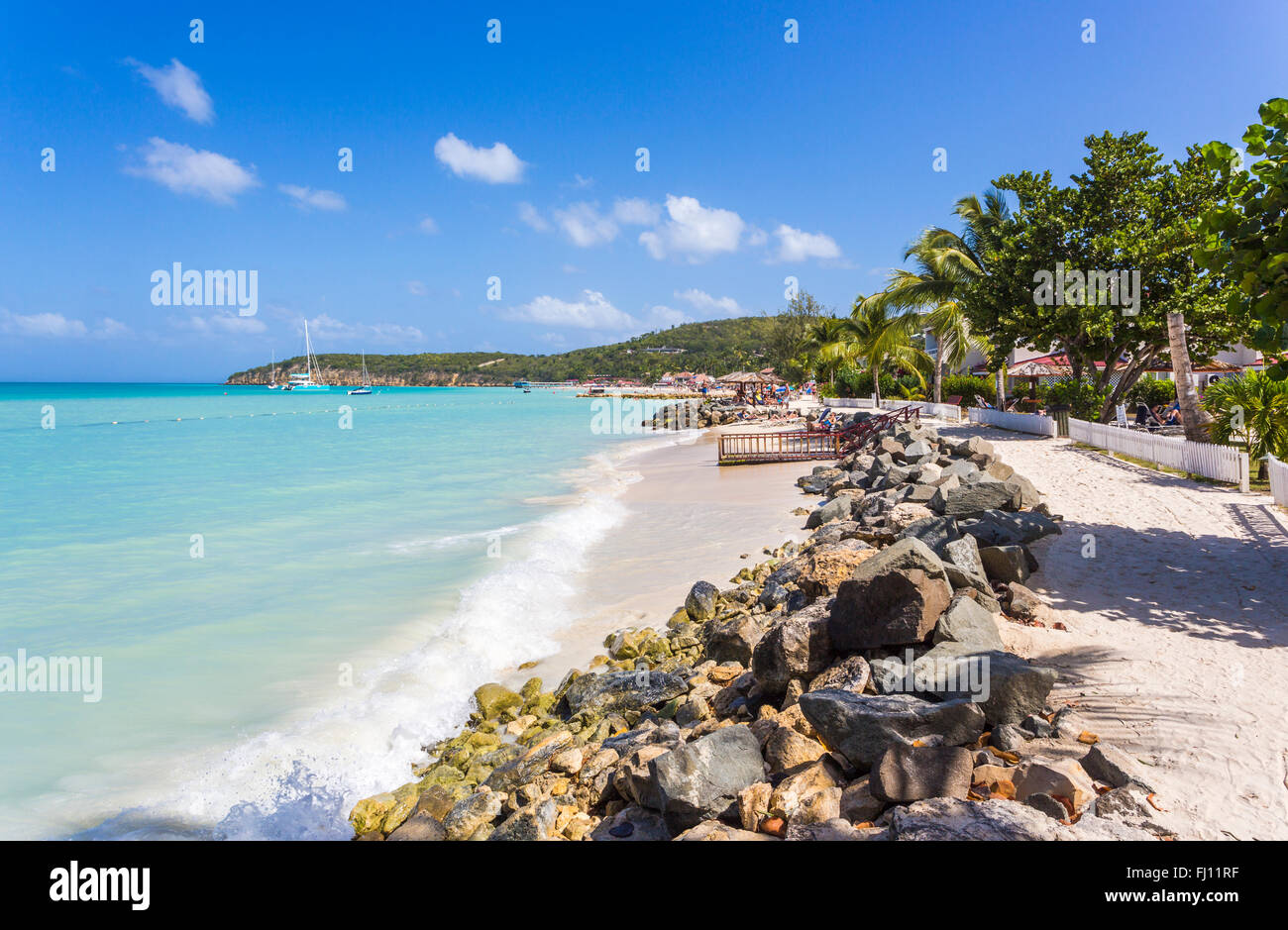 Dickenson Bay beach in north Antigua with blue sky and turquoise sea on a sunny day, Antigua and Barbuda, West Indies Stock Photo