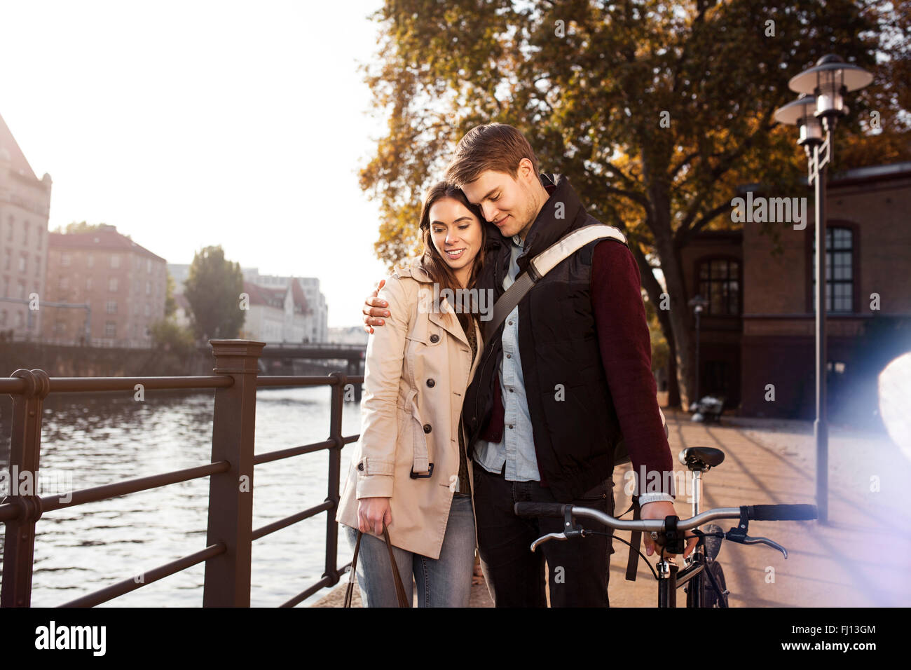 Young couple hugging riverside hi-res stock photography and images - Alamy