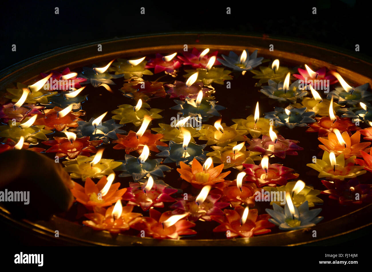 Colorful Candle floating on water for pray buddha at Sai Yai Temple in