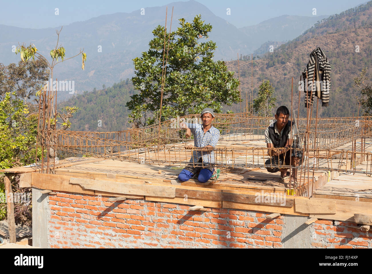 Builders working on a earthquake-proof house in Pipaldanda, Nepal Stock Photo