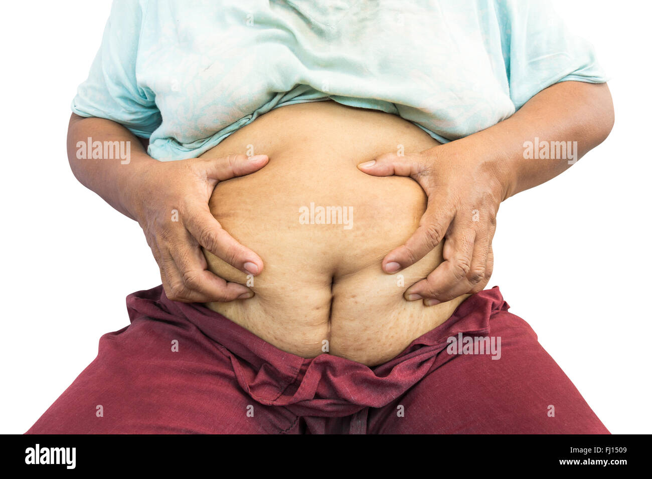 asian old fat woman grasp her abdomen ( surgical scar at lower abdomen ( post cesarean section ) ) ( isolated background ) Stock Photo