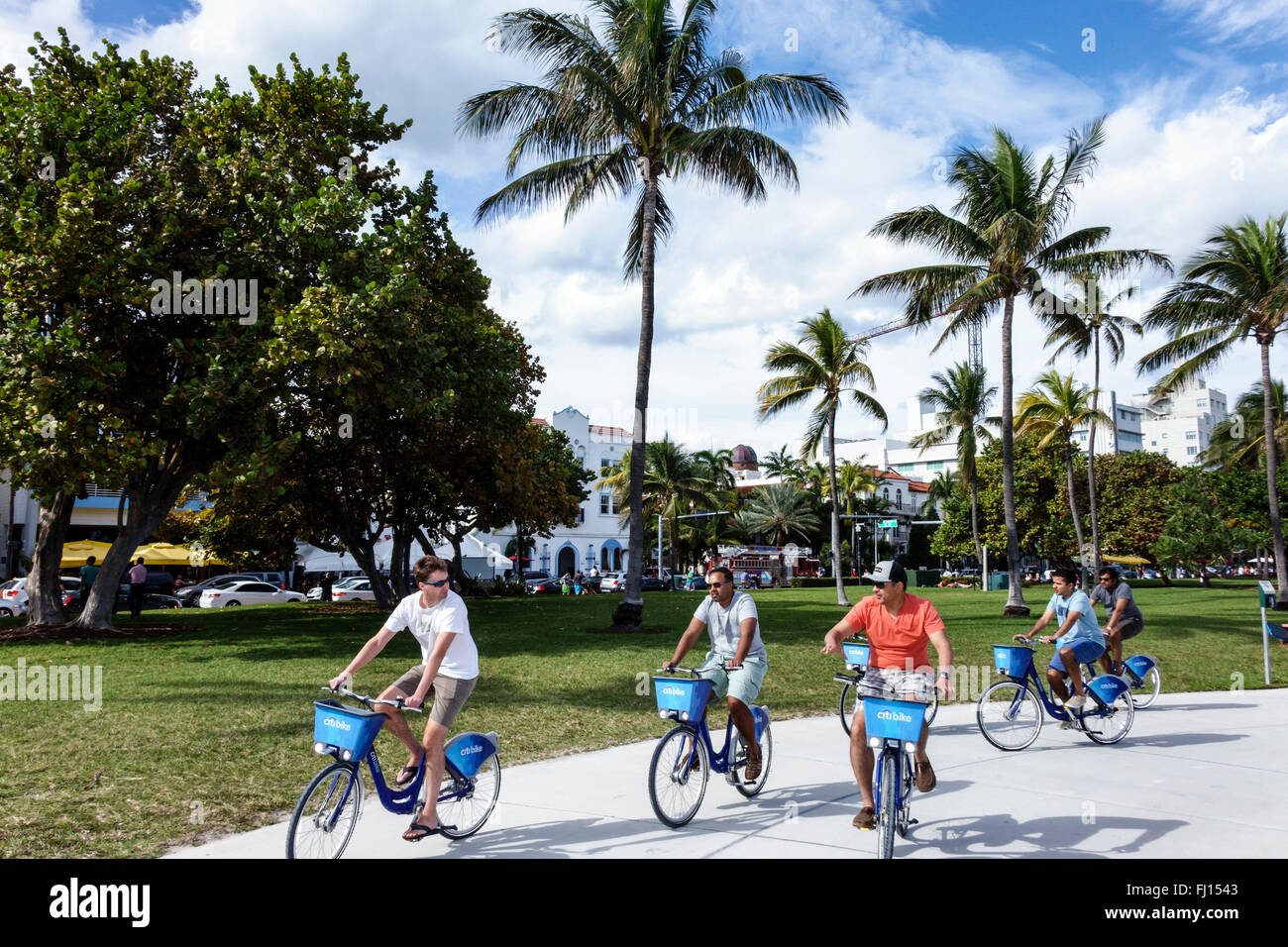 Florida,South,FL,Miami Beach,Lummus Park,Serpentine Trail,Citibike station,bike share program,adult,adults,man men male,riders,riding,bicycles,visitor Stock Photo