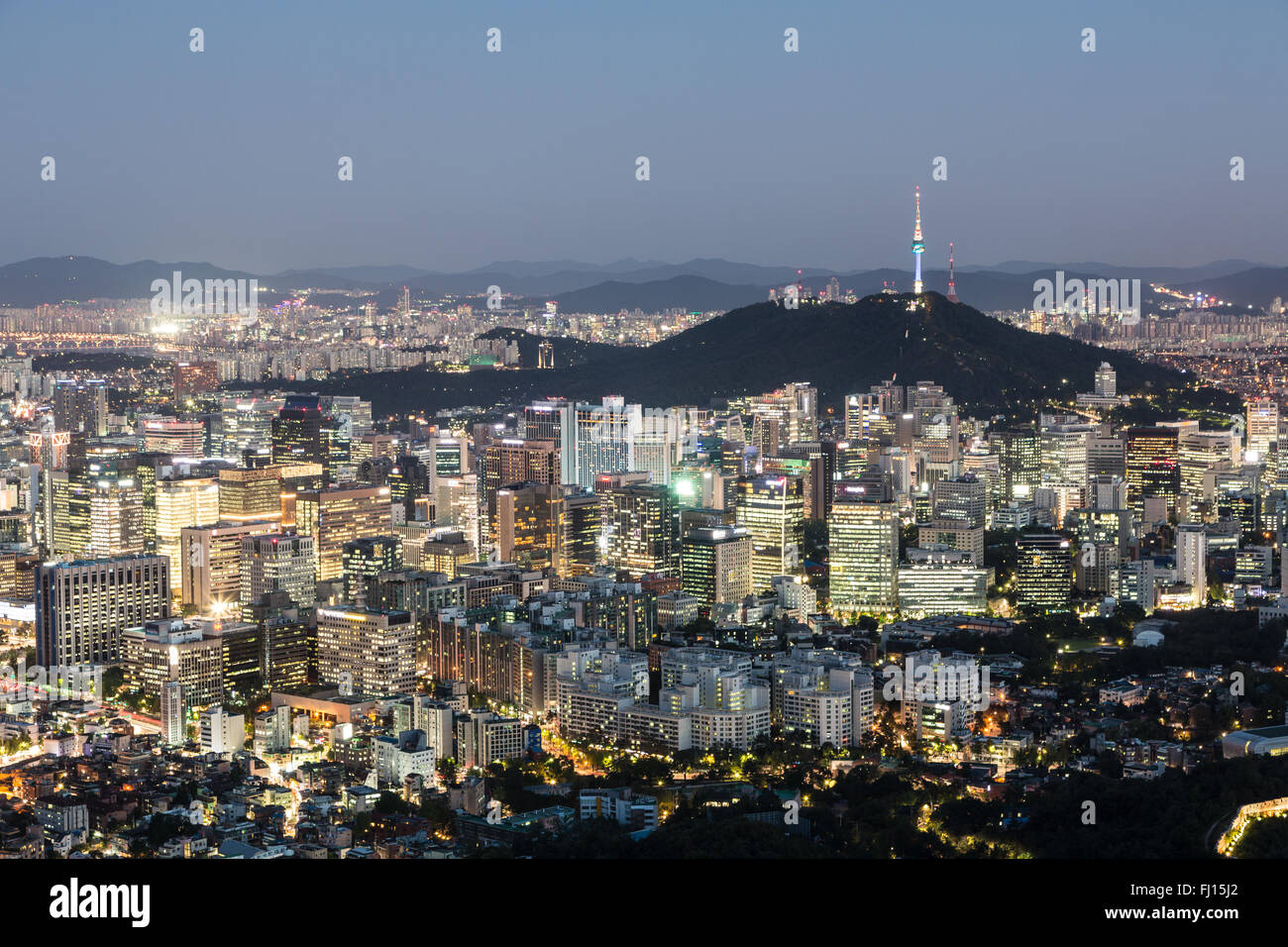 An aerial view of Seoul business district at night with the Namsan mountain. Seoul is South Korea capital city. Stock Photo