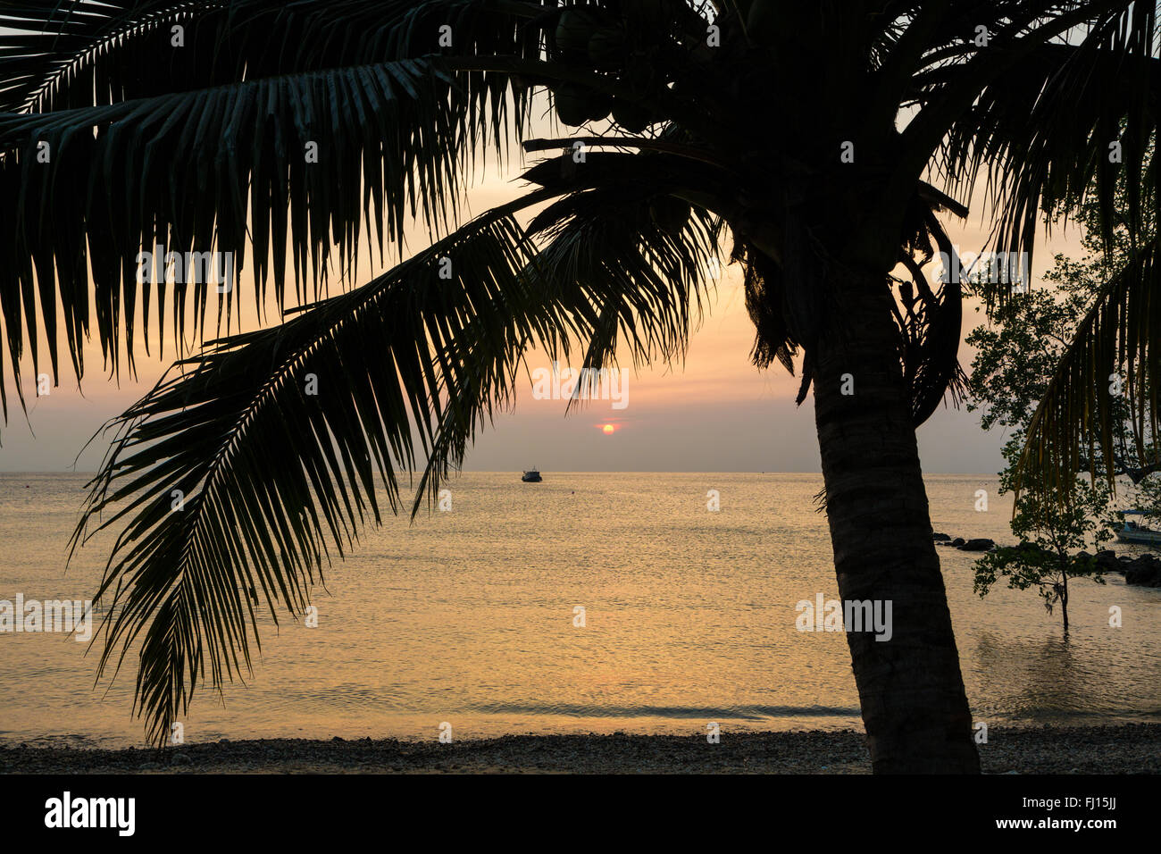 Sunset over a lonely beach in the Tioman island in Malaysia Stock Photo