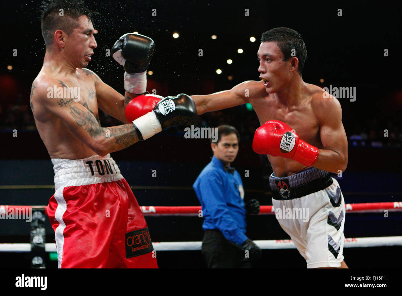 Waterfront Hotel,Cebu City,Philippines 27/02/2016.Pinoy Pride 35 'Stars of The Future' boxing event.Filipino Kevin Jake 'KJ' Cataraja (white trunks), battles with Tony Rodriguez of Mexico in a Flyweight match up.Cataraja taking the 8 round fight by decision. Stock Photo