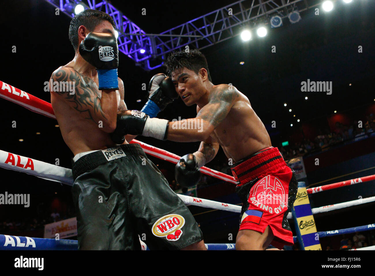 Waterfront Hotel,Cebu City,Philippines 27/02/2016.Pinoy Pride 35 'Stars of The Future' boxing event.Filipino Mark 'Magnifico' Magsayo (red & black Trunks), the current IBF Youth Featherweight champion takes the offensive against Eduardo 'Fierita' Montoya of Mexico for the WBO youth Featherweight Championship Stock Photo