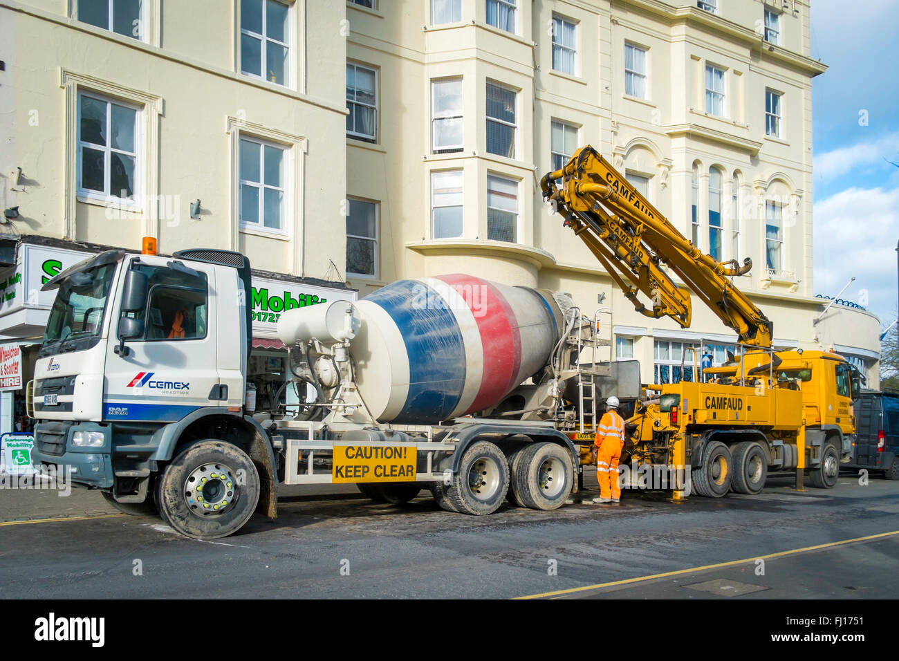 Truck mounted mobile concrete mixer and a mobile concrete pump setting up  ready to work Stock Photo - Alamy