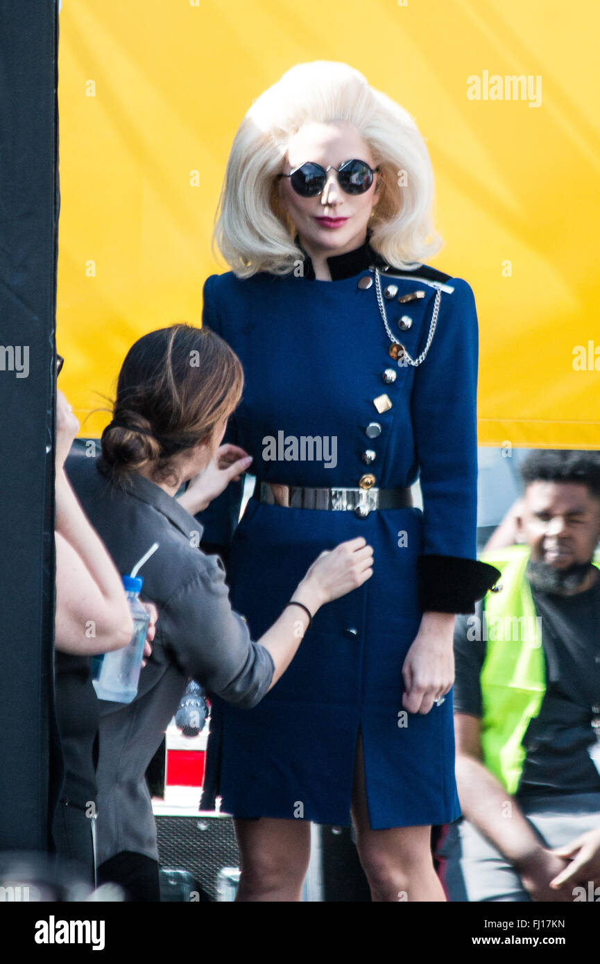 Los Angeles, California, USA. 27th February, 2016. Lady Gaga is backstage with a worker helping her get ready for her stage performance with Elton John at his free concert on the Sunset Strip in Los Angeles, California, USA. Credit:  Sheri Determan/Alamy Live News Stock Photo