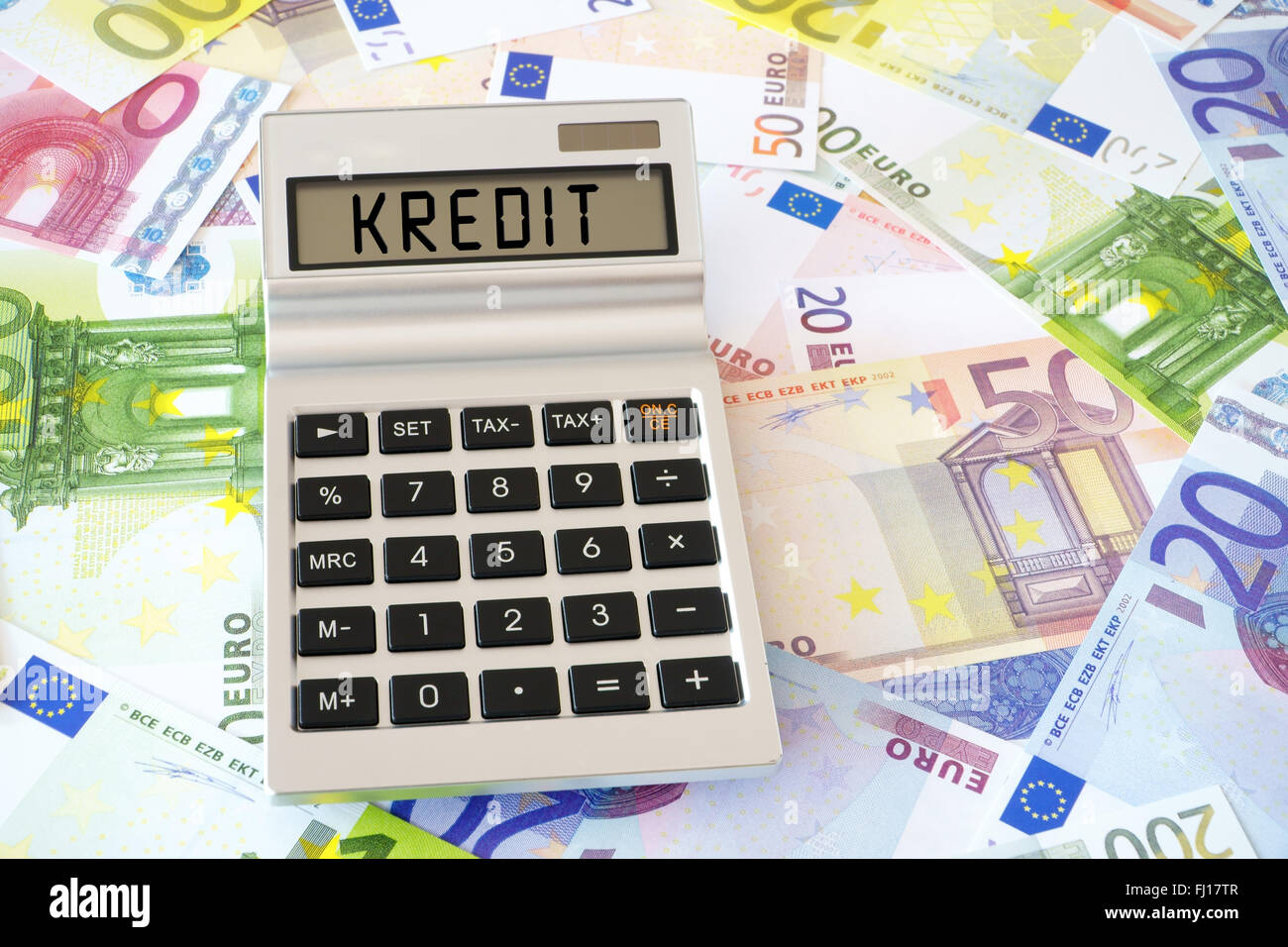 Pocket calculator with the the german Word Kredit (english translation –  Credit) on the display. In the Background many euro ban Stock Photo - Alamy