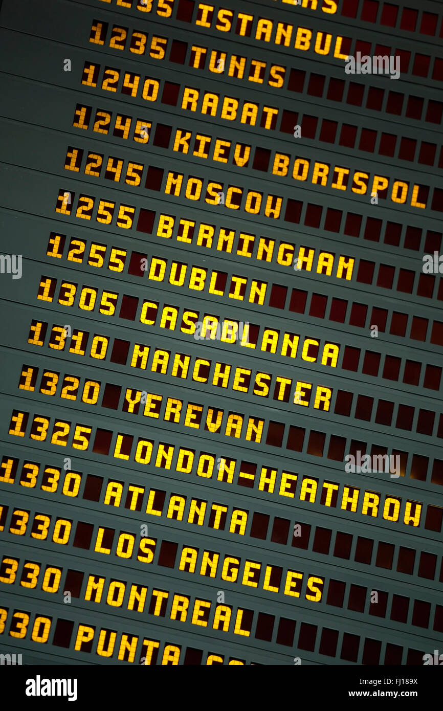 Airport departures and arrivals flight times board Stock Photo