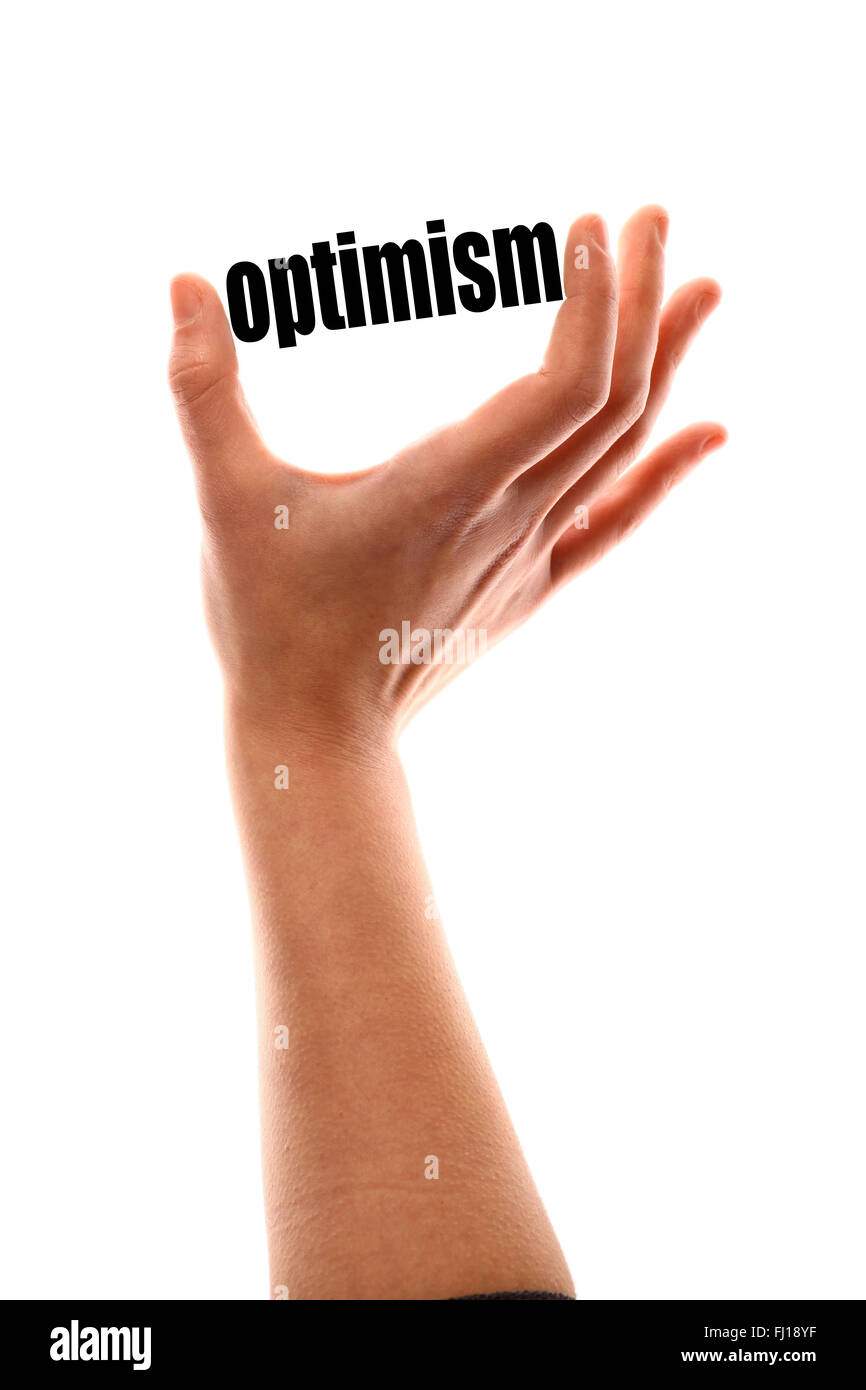 Color vertical shot of a of a hand squeezing the word 'optimism'. Stock Photo