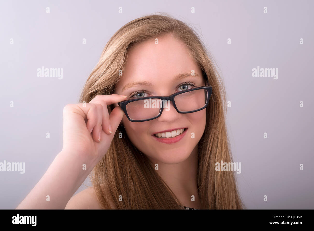 Attractive teenage girl wearing spectacles with a black frame Stock Photo
