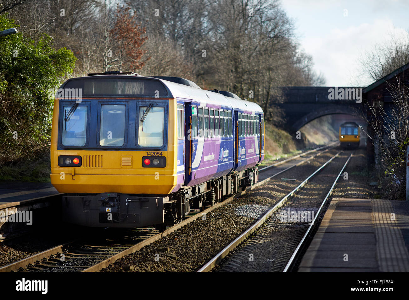 Norther Rail class 142 Pacer leaves Reddish North as a second arrives   Transport transporter transportation transported traveli Stock Photo