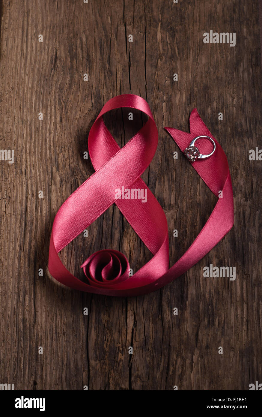 Beautiful pink ribbon with ring, gifts for women's day Stock Photo - Alamy