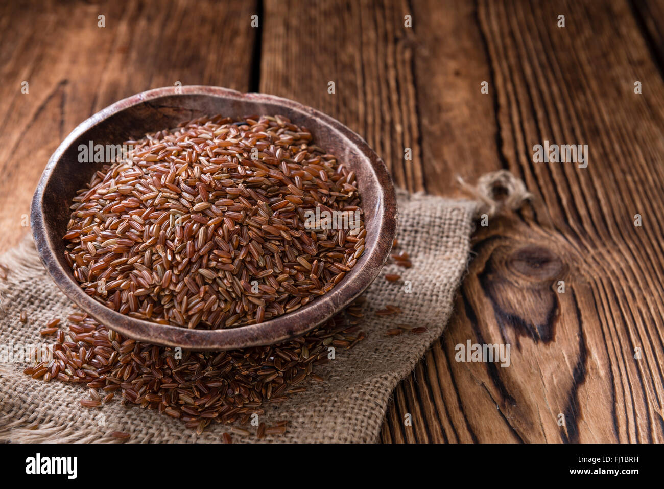 Old Red Rice An old wooden table with a portion of red Rice (close-up shot Stock ...